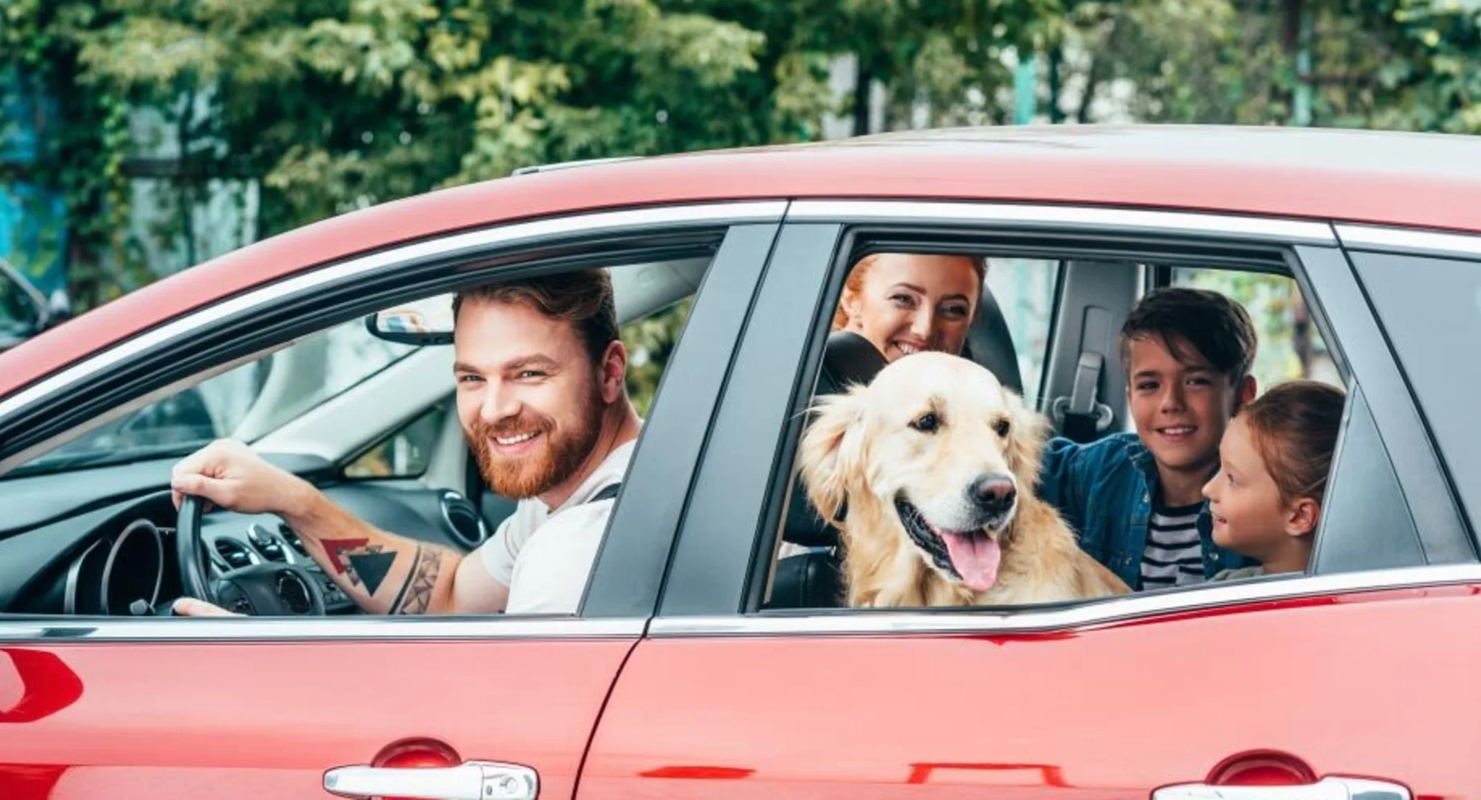 Family in car with a dog